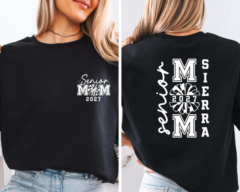 May include: Black sweatshirt with white text and a cheerleading design. The front features "Senior Mom 2027" with a pom-pom graphic. The back displays "Senior" vertically, with "MOM 2027 SIERRA MA" in a cheerleading font.