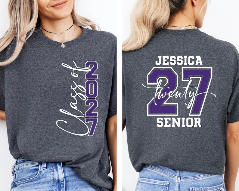 May include: Charcoal gray t-shirt with the text "Class of 2027" in white script and purple block letters. The back of the shirt features the name "Jessica", the number "27", and the word "Senior".
