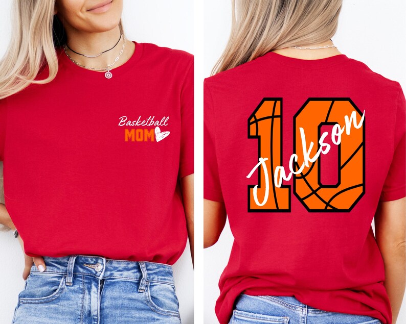 Peut inclure: T-shirt rouge avec le texte "Basketball Mom" et un c&oelig;ur sur le devant. Le dos du t-shirt pr&eacute;sente un motif de basket-ball avec le num&eacute;ro 10 et le nom "Jackson" &eacute;crit dessus.