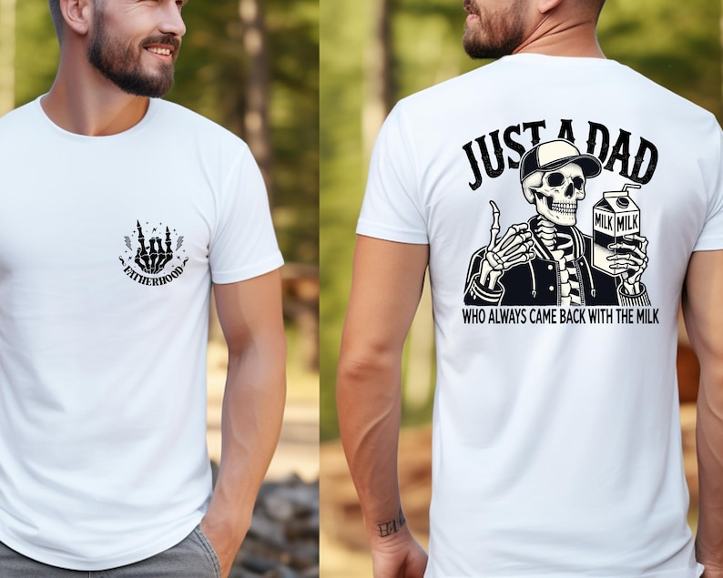 May include: White t-shirt with a black graphic on the front that says "FATHERHOOD" and a skeleton hand design. The back of the shirt features a skeleton wearing a hat and jacket, holding a milk carton, with the text "JUST A DAD WHO ALWAYS CAME BACK WITH THE MILK."