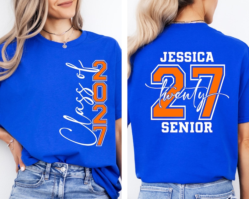 May include: Royal blue t-shirt with the text "Class of 2027" in white script and orange block letters. The back of the shirt features the name "Jessica", the number "27", and the word "Senior" in white and orange.