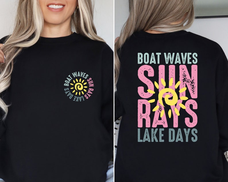 May include: Black sweatshirt with a sun graphic and the text "Boat Waves Sun Rays Lake Days" on the front and back. The sun graphic is yellow with a yellow swirl in the center. The text is in a variety of colors, including pink, blue, and green.