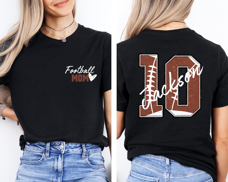 May include: Two black t-shirts with a football theme. The front shirt says "Football Mom" with a small heart. The back shirt has a large number "10" with the word "Jackson" written inside the number. The number is made to look like a football.