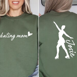 May include: Green sweatshirt with the text "skating mom" and a small heart on the front. The back of the sweatshirt has a white silhouette of a figure skater with the name "Josie" written next to it.