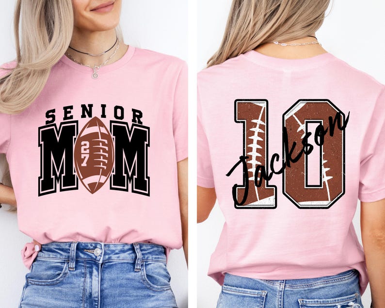 May include: A light pink t-shirt featuring a front graphic with the text SENIOR MOM and a football icon with the number 27. The back of the shirt displays the number 10 with a football texture and the name Jackson written in black script.