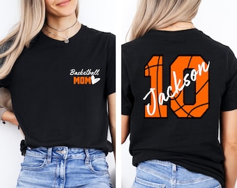 May include: Black t-shirt with the text "Basketball Mom" and a heart on the front. The back of the shirt has a basketball-shaped number 10 with the name "Jackson" written inside.
