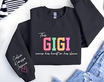 Gigi Sweatshirt, Custom Gigi Sweater This Gigi Wears Her Heart On Her Sleeve Sweater,With Kids Name On Sleeve, Custom Grandma Gift,Gigi Gift