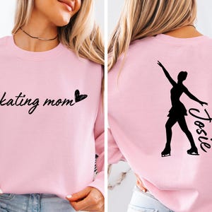 May include: Pink sweatshirt with the text "skating mom" and a heart on the front. The back of the sweatshirt has a silhouette of a figure skater with the name "Josie" written next to it.