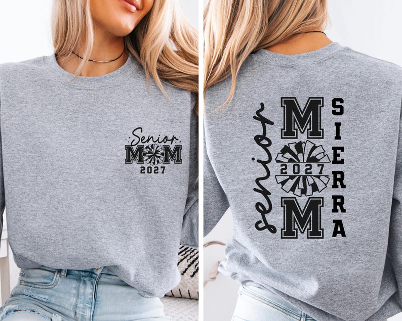 May include: A heather gray sweatshirt with black text and a pom-pom graphic. The front of the sweatshirt reads "Senior Mom 2027." The back of the sweatshirt says "Senior Sierra Mom 2027" in a vertical layout.
