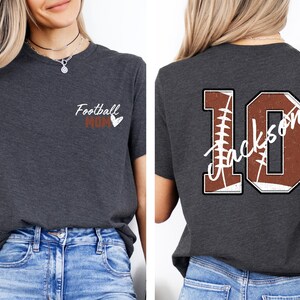 May include: Two t-shirts, one with the text "Football Mom" and a heart, the other with a football jersey design with the number "10" and the name "Jackson".