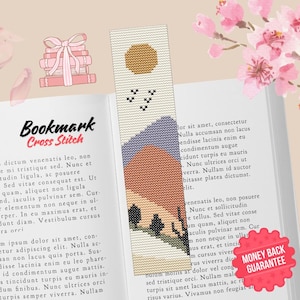 May include: Cross stitch pattern for a bookmark featuring a sunset landscape with a yellow sun, purple and orange mountains, and a few birds flying in the sky. The bookmark is designed to be stitched on Aida cloth.