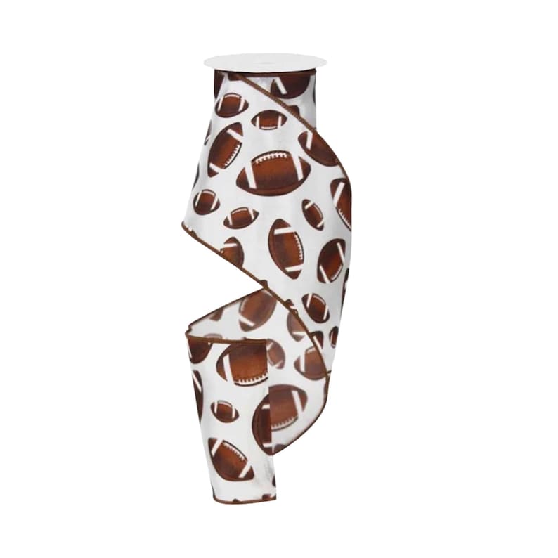 May include: A roll of white ribbon featuring a repeating pattern of brown American footballs with white laces. The ribbon has a brown finished edge and is wound around a central spool, displaying a continuous print of various sized footballs.