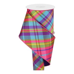 May include: A roll of colorful plaid ribbon. The ribbon features a vibrant pattern of pink, purple, blue, and yellow squares. The ribbon is wrapped around a white cardboard core, perfect for crafting and gift wrapping.