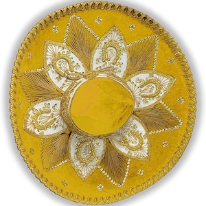 May include: A yellow sombrero with detailed gold embroidery and white floral patterns. The hat has a rounded crown and a broad, circular brim, edged with gold trim. The design incorporates gold stitching and sequins, giving a celebratory appearance.