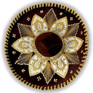 May include: A brown sombrero with detailed gold embroidery and white floral patterns. The hat has a decorative gold trim around the edge and a central brown crown. This traditional Mexican hat is a festive accessory.