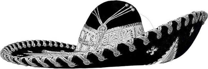 May include: A black sombrero with silver embroidery and trim. The hat features a wide brim and a rounded crown, with intricate floral and geometric patterns. The hat is a traditional Mexican garment.