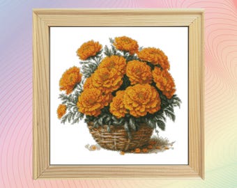 May include: A framed cross-stitch embroidery of a bouquet of orange marigolds in a woven basket.