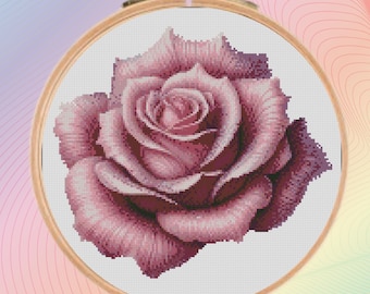 May include: A single, large, pink rose with a detailed, realistic design. The rose is in a white background.
