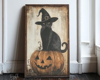 May include: A framed Halloween-themed artwork featuring a black cat wearing a witch hat, perched atop a carved pumpkin. The artwork has a vintage, distressed look with a wooden frame and the text "twinkle & tonic" in the lower left corner.