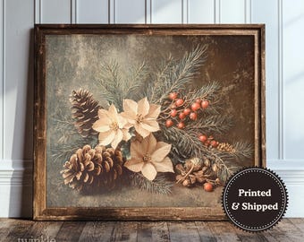May include: A framed print featuring a vintage botanical arrangement. The artwork showcases beige poinsettias, pinecones, red berries, and evergreen branches. The print is set against a muted background, with the words "Printed & Shipped" on a circular sticker.