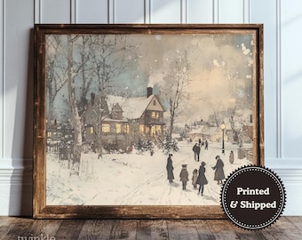 May include: A framed winter landscape print featuring a snow-covered village scene with houses, trees, and figures. The artwork has a vintage aesthetic with soft colors and a warm glow from the lit windows. The print is in a brown wooden frame.