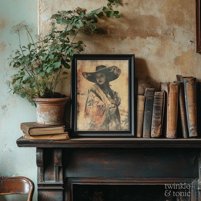 May include: A framed portrait of a woman wearing a large hat and shawl, displayed on a dark wooden mantelpiece. The portrait is surrounded by old books, a potted plant, and a vintage aesthetic.