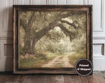 May include: A framed print of a scenic dirt road winding through a forest, under a large tree with Spanish moss. The artwork has a vintage aesthetic, with soft colors and a rustic wooden frame. The print is labeled "Printed & Shipped".