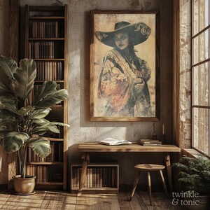 May include: A framed vintage portrait of a woman wearing a large hat and shawl hangs above a wooden desk. The room features a bookshelf, a potted plant, and a window with natural light. The overall aesthetic is rustic and warm.