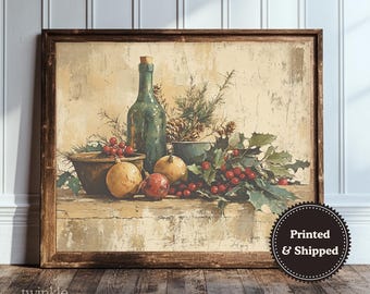 May include: A framed still life print featuring a green bottle with a cork, bowls, and fruit. The artwork includes red berries, pinecones, and greenery, with a vintage aesthetic. The print has a brown wooden frame and is displayed on a wooden surface.