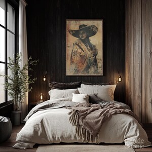 May include: A framed artwork depicting a woman in a wide-brimmed hat and shawl, displayed above a bed with neutral-toned bedding. The room features dark wood paneling and a window with natural light, creating a cozy atmosphere.