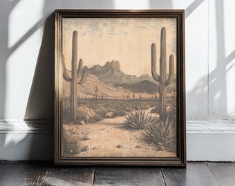 May include: Framed vintage-style print featuring a desert landscape with cacti, mountains, and a dirt path. The artwork is in sepia tones, with a dark brown wooden frame. The print evokes a sense of the American Southwest.