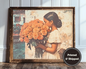May include: A framed wall art print depicting a person with dark hair in a light-colored dress holding a large bouquet of orange roses. The background features a textured wall and a glimpse of a building. A circular badge reads Printed & Shipped.