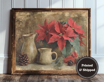 May include: A framed print featuring a still life with red poinsettias, two ceramic pitchers, and pine cones. The artwork has a vintage aesthetic with a brown wooden frame and a neutral background. The text "Printed & Shipped" is visible.
