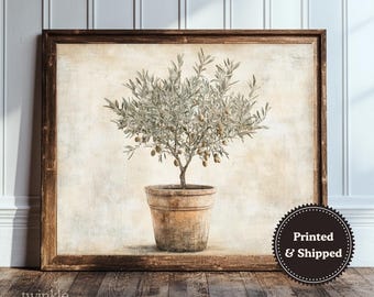 May include: A framed print featuring an olive tree in a terracotta pot. The artwork has a vintage aesthetic with a neutral color palette. The print is displayed on a wooden surface, with the text "twinkle & tonic" in the lower left corner.