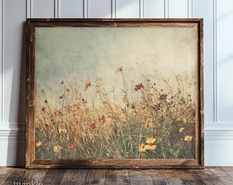 May include: A framed print featuring a field of wildflowers in shades of yellow, red, and brown. The artwork has a vintage aesthetic, with a soft blue sky background. The wooden frame adds a rustic touch to the floral art.