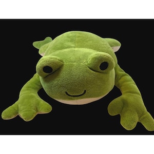 May include: A large, plush green frog toy with big, round eyes and a smiling mouth. The frog has long arms and legs, and is lying flat. The toy is made of soft material and is designed to be cuddly.