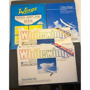 May include: A set of four paper airplane books and kits. The books are titled "Wings: The Step-by-Step Paper Airplane Book" and "Whitewings: Excellent Paper Airplanes Collection Series". The kits are titled "Whitewings: Official Edition 15 Carefully Selected Models" and "Whitewings: Official Edition 15 Excellent Paper Airplanes Collection Series".