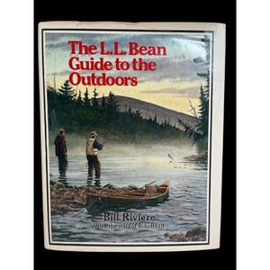 May include: The L.L. Bean Guide to the Outdoors book cover. The cover features a watercolor illustration of two people fishing in a lake with a canoe. The text reads "The L.L. Bean Guide to the Outdoors" and "Bill Riviere".