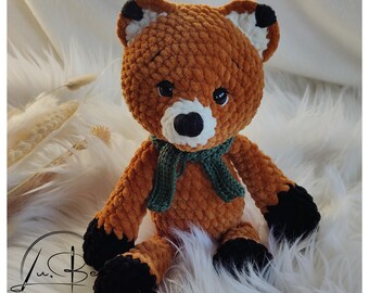 May include: A crocheted fox plush toy with a green scarf. The fox has black eyes, a white nose, and black paws.