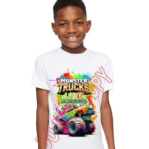 Może przedstawiać: Biała koszulka z kolorową grafiką przedstawiającą monster trucka. Grafika zawiera tekst "Monster Trucks Live Glow Party".