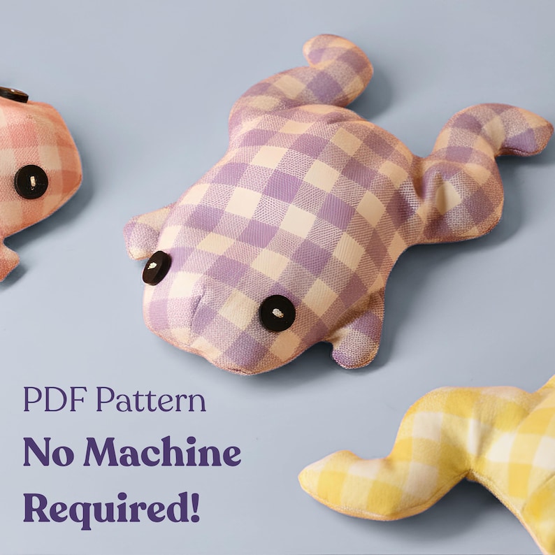 May include: Three handmade frog plushies in the image. The frogs are made of gingham fabric in pink, purple, and yellow. Each frog has black button eyes. The text "PDF Pattern No Machine Required!" is in the lower left corner.