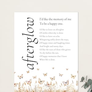 May include: A white print with the word "afterglow" in a vertical script. The print features a poem about memories and butterflies. Butterflies and floral elements are at the bottom of the print.