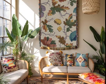 May include: A cozy living room scene featuring a floral tapestry, a rattan sofa with patterned pillows, and a colorful rug. The tapestry has a cream background with large flowers and foliage. The room is filled with natural light.
