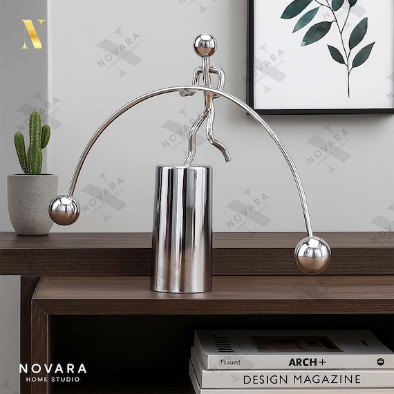 66 favorites on a $27 kinetic balance pendulum proves this is a proven gifting hit — physics-in-action desk art that's accessible and shareable.