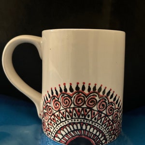 Hand painted design on coffee/tea mug. Ideal gift or for self