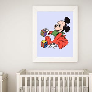 May include: A framed print of a cartoon baby Mickey Mouse wearing a red onesie and a green bib, playing with colorful blocks on a light blue background.