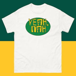 May include: White t-shirt with a green circle containing the text "Yeah, Nah" in yellow.