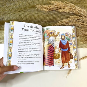 May include: An illustration from a children's book depicting a man in a red and black robe talking to another man in a blue robe. The text reads "The right wife for Isaac." The illustration is set in a desert landscape with camels and other people in the background.