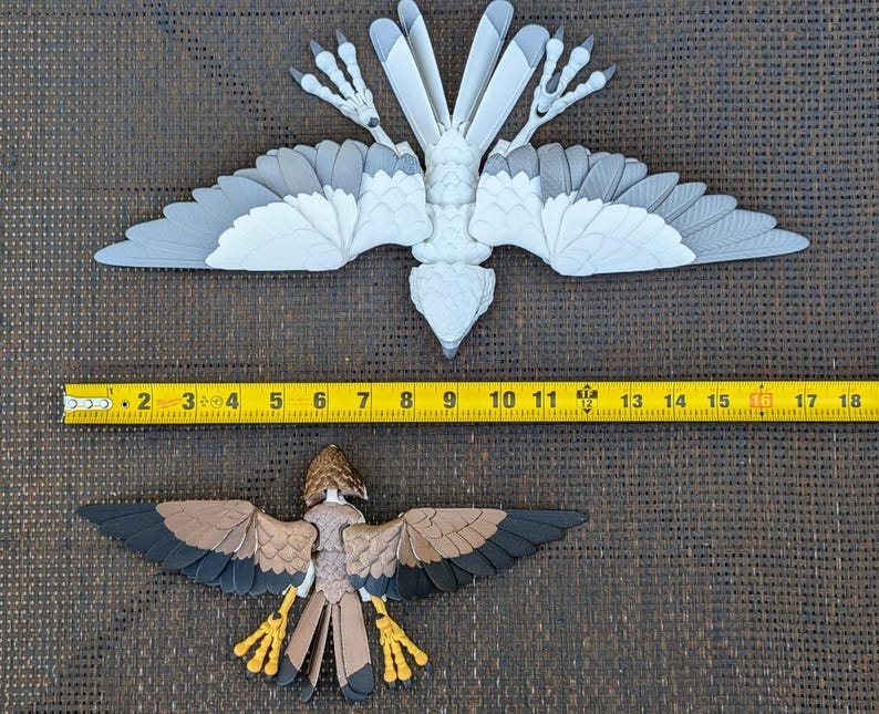 May include: Two bird models, one white and one brown, with detailed wings and legs. The white bird is larger and has a wingspan of approximately 17 inches. The brown bird is smaller and has a wingspan of approximately 10 inches.
