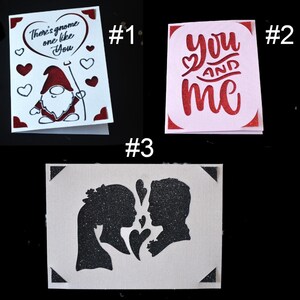 May include: Three Valentine's Day cards with different designs. The first card features a red gnome with a heart balloon that says "There's gnome one like you". The second card is pink and says "you and me" in red. The third card features a black silhouette of a couple with hearts.